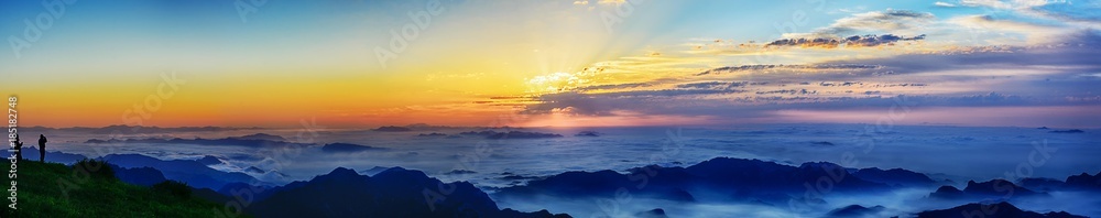 Sunset above the clouds in the sky with sun beams on evening time.