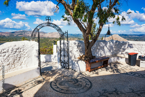 Iron gate and bronze bell in Tsambika Monastery, (RHODES, GREECE)