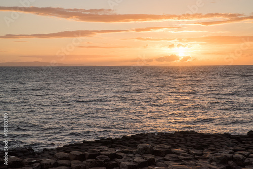 Landscape view of the ocean at Giant's Causeway in Ireland during sunset. 