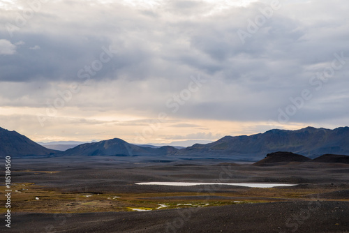 A bare landscape with background mountains and clouds in Iceland.  © Rosemary
