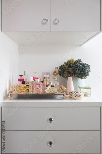 Collection of perfume bottles in a female dressing room photo