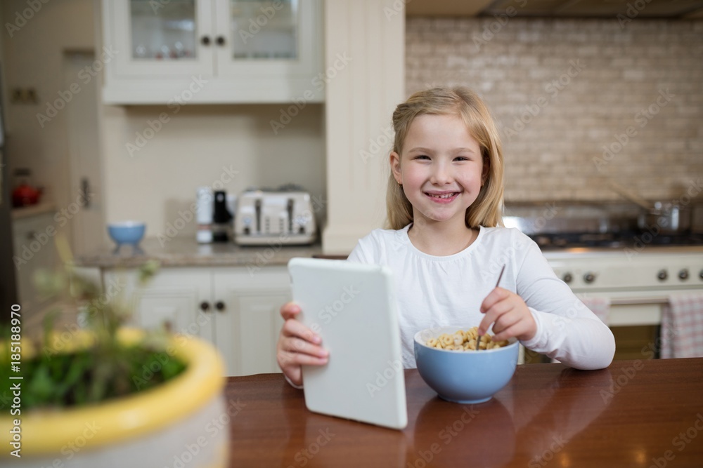 Young girl having breakfast in the kitchen at home Young girl having breakfast in the kitchen at home