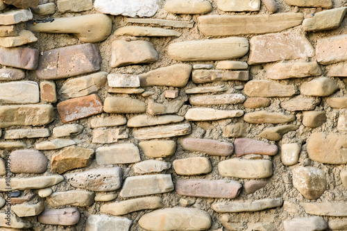 Masonry walls made of natural sea boulders, closeup, concept of ancient buildings photo