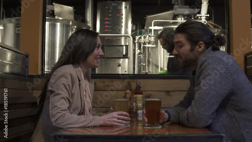 Woman filling a glass with beer from a tap photo