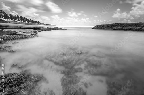 Long exposure landscape black and white on the beach with rocks