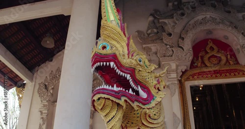 CHIANG MAI, THAILAND, MARCH 2017: Rotating view of Dragon statue outsude Temple photo