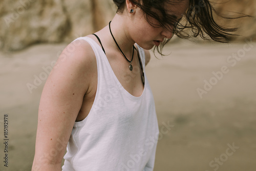 Closeup Lifestyle Photo of Woman / Girl with her Hair Blowing in the Wind Outdoors photo