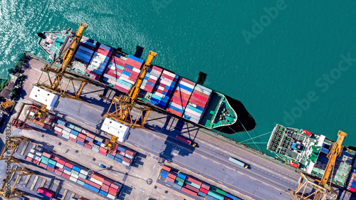 Logistics and transportation of Container Cargo ship and Cargo plane with working crane bridge in shipyard at sunrise, logistic import export and transport industry background