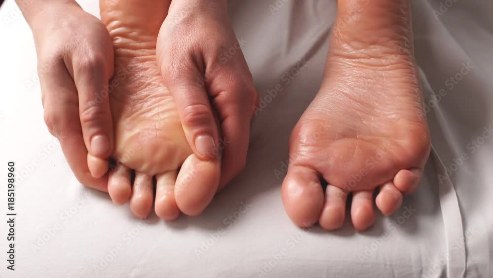 Closeup of Young Woman Receiving Professional Feet Massage in Spa Center. Closeup of Young Woman Receiving Professional Feet Massage in Spa Center.