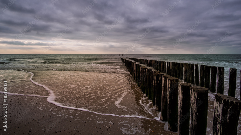 Wooden pier during cloudy weather at the beach in Vlissingen, Zeeland, Holland, Netherlands