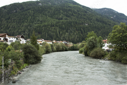 Flowing and motion of water very fast from rainstrom in Bad inn river at Pfunds village in Tyrol, Austria photo