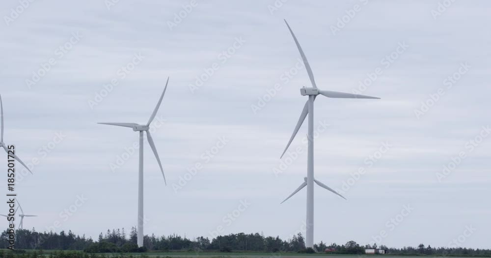 Wind turbines spinning - pan shot - slow motion Wind turbines spinning - pan shot - slow motion
