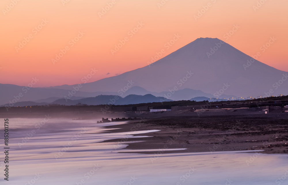Mountain Fuji and sea wave in sunset at Southern Beach Chigasaki beach , Kanagawa prefecture , Japan