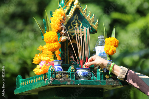 Asian people with incense pay respect to shrine or spirit worship