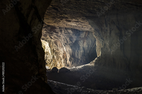 The rays of light make their way through the entrance to the old dark cave.