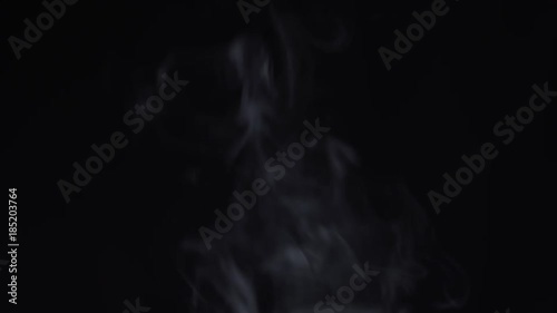 Steam rises on a black background