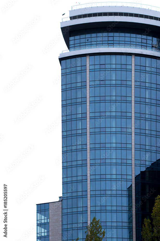 Naklejka premium Office glass buildings on a cloudy sky background