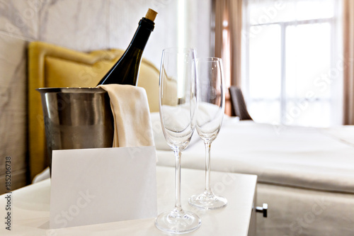 Honeymoon concept. Champagne bucket near bed in a hotel room