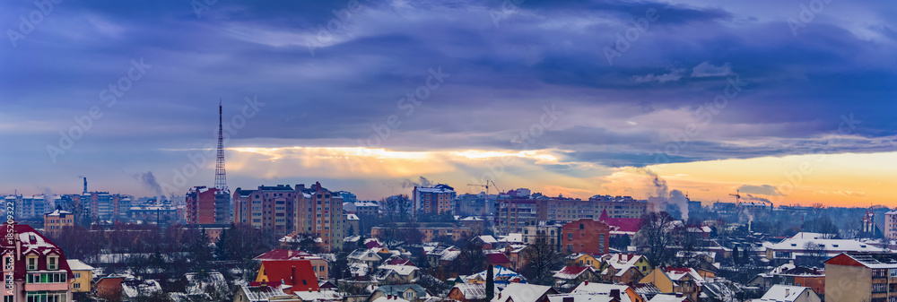 rays of the sun make their way through dramatic clouds over the city of Ivano-Frankivsk, Ukraine