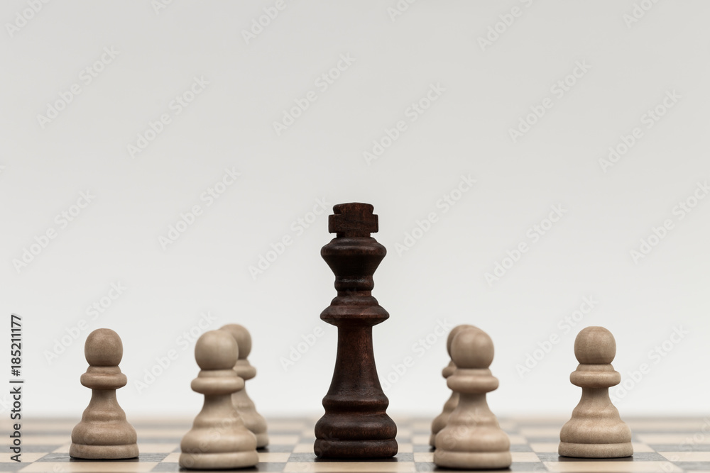Chess pieces on a chess board with the king and pawns Chess pieces on a chess board with the king and pawns