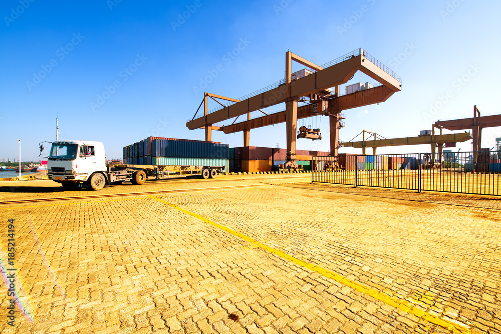 Fototapeta premium Industrial container yard of logistics import and export business under the blue sky
