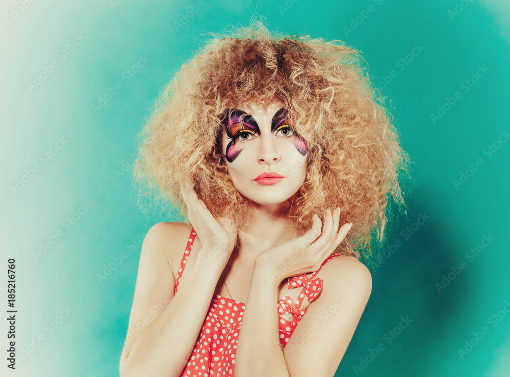 Naklejka premium Close-up portrait of beautiful sprite girl with butterfly faceart on tiffany blue background