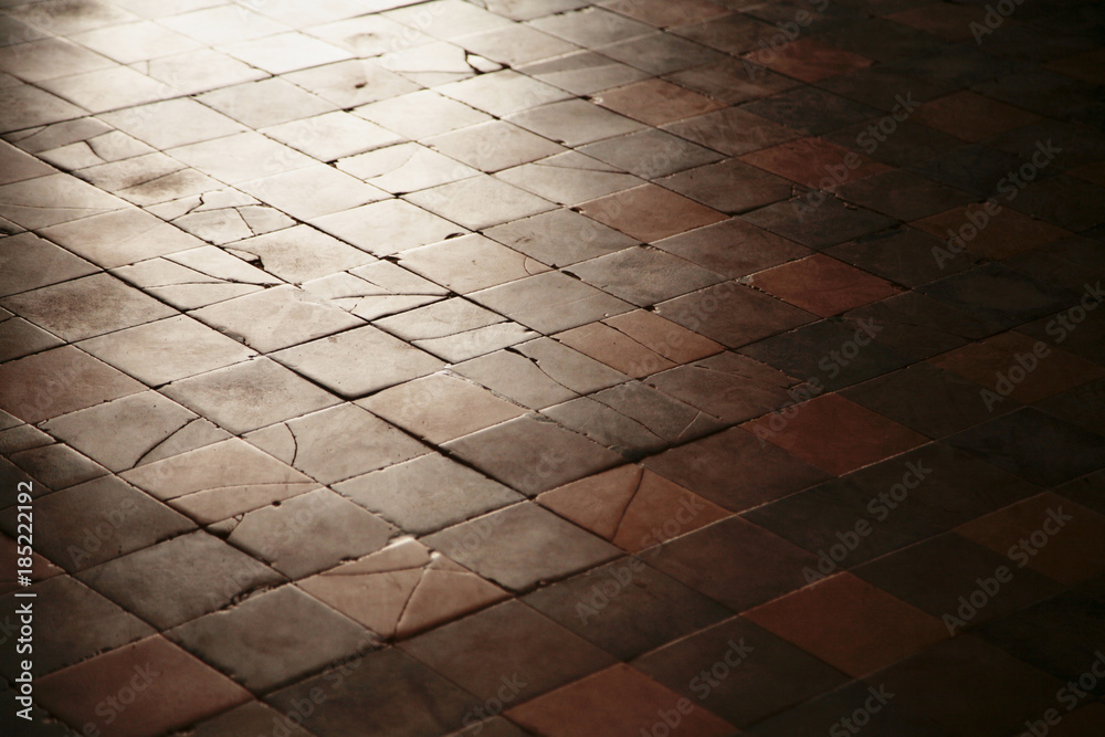 Old with cracked stone tiles on the floor of the old building