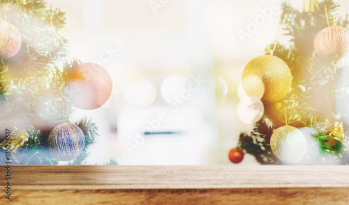 Wooden desk with double exposure Christmas decoraions and Bokeh lights background photo