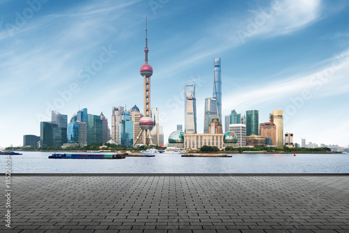 clean asphalt road with city skyline background,shanghai,china. photo