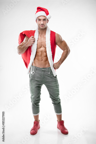 Obraz na plátně sexy guy wearing santa claus clothes