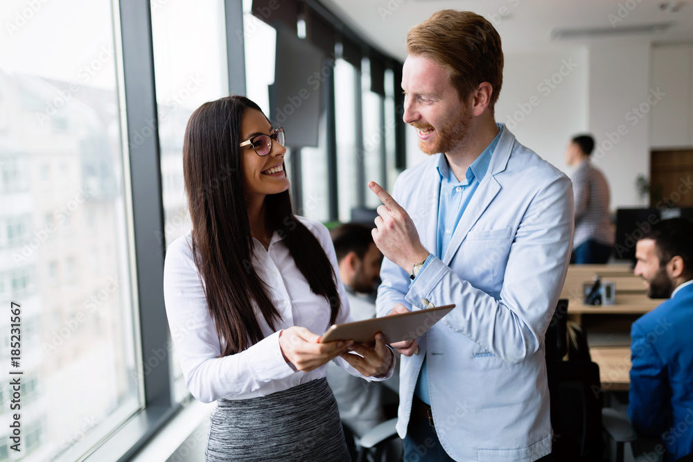 Obraz premium Attractive business couple using tablet in their company