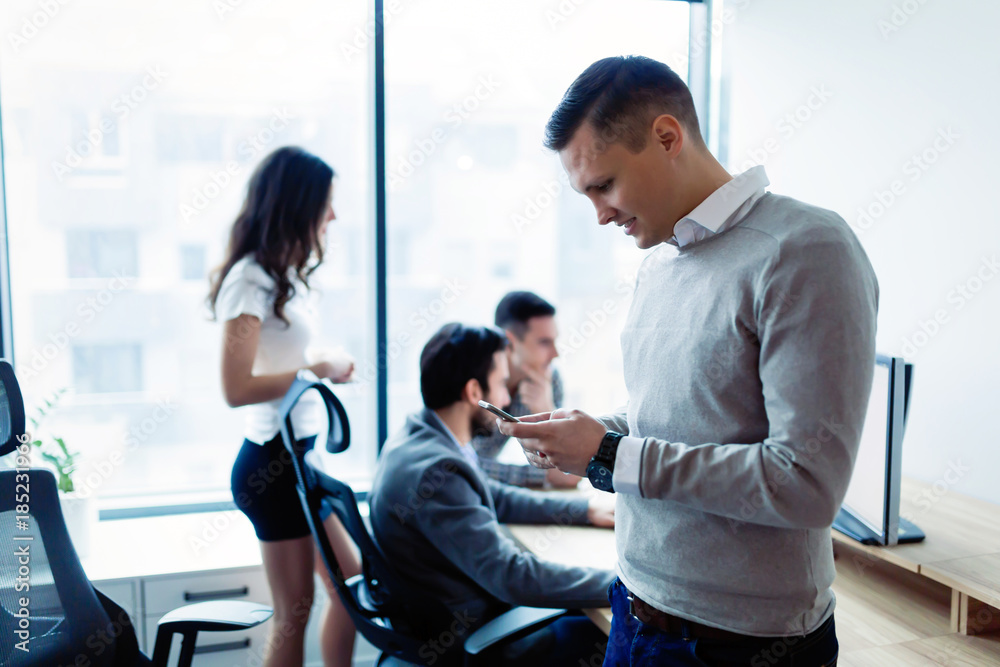 Portrait of young businessman using mobile phone Portrait of young businessman using mobile phone