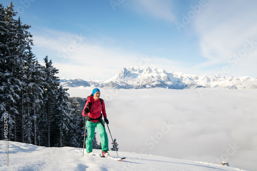 A woman does cross country skiing in fresh powder snow at Werfenweng near Salzburg.