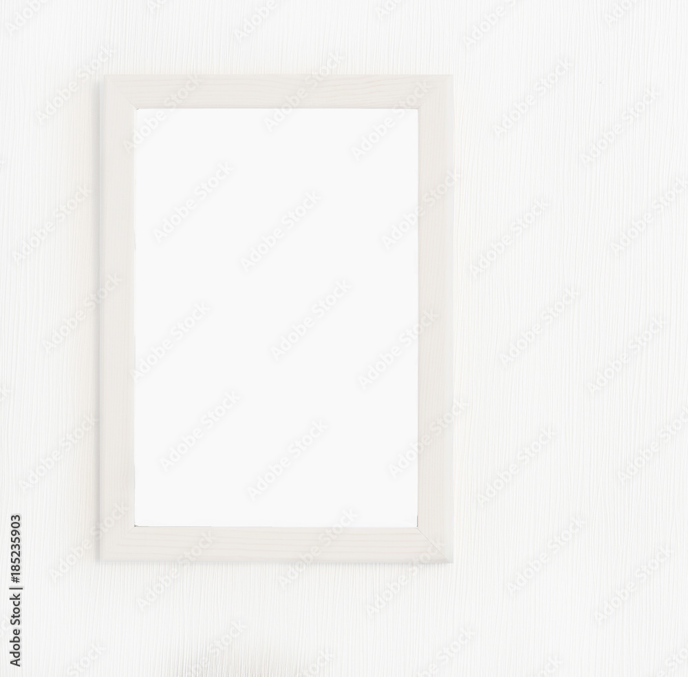 Fototapeta premium Light wooden frame for picture hanging on white wall. Blank picture. Template for design