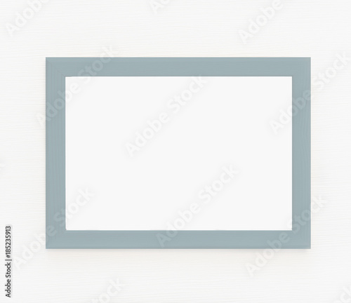 Light  wooden frame for picture hanging on white wall. Blank picture. Template for design