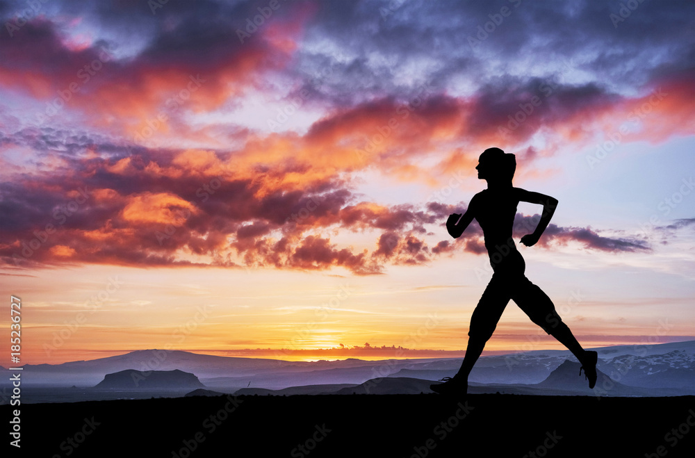 A sports girl at dawn is engaged in yoga. Fitness classes at sunset
