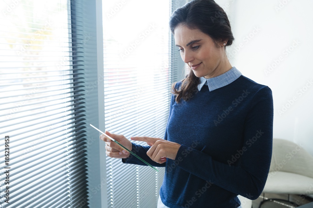 Female executive using glass digital tablet Female executive using glass digital tablet