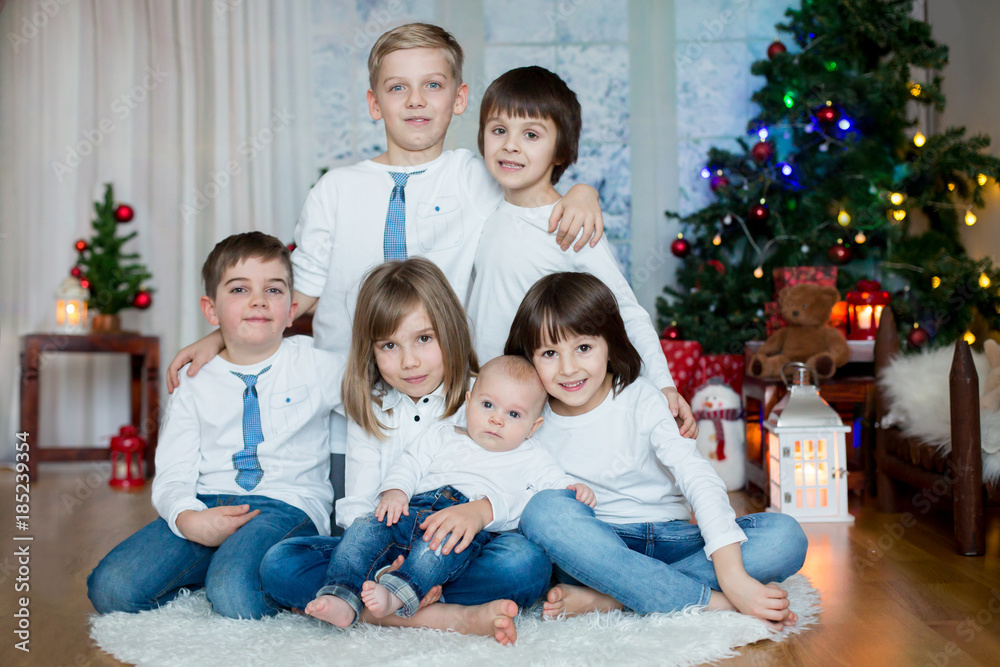 Five cute children, brothers, sister, siblings and friends, having fun on Christmas