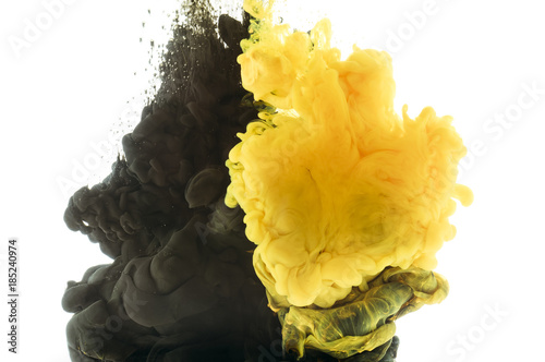 mixing of black and yellow paint, isolated on white photo