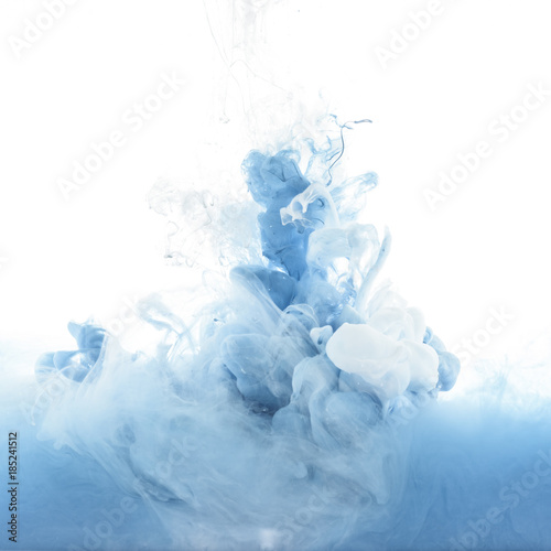 close up view of mixing of blue and white paint splashes isolated on white