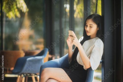 Business woman is using smartphone © Songsak C