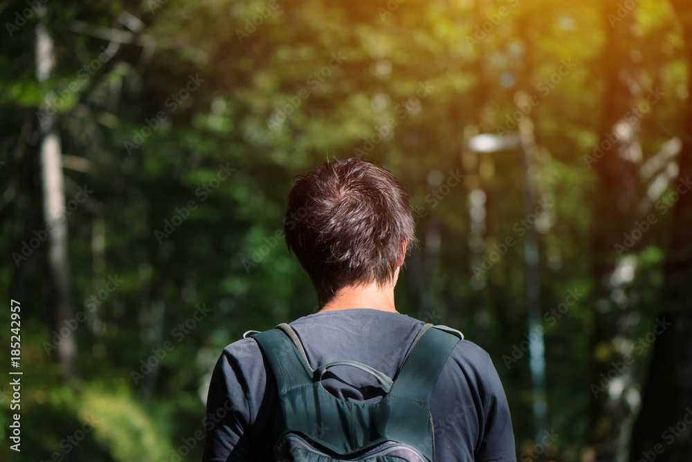 Man with backpack enjoying walk in the park Man with backpack enjoying walk in the park