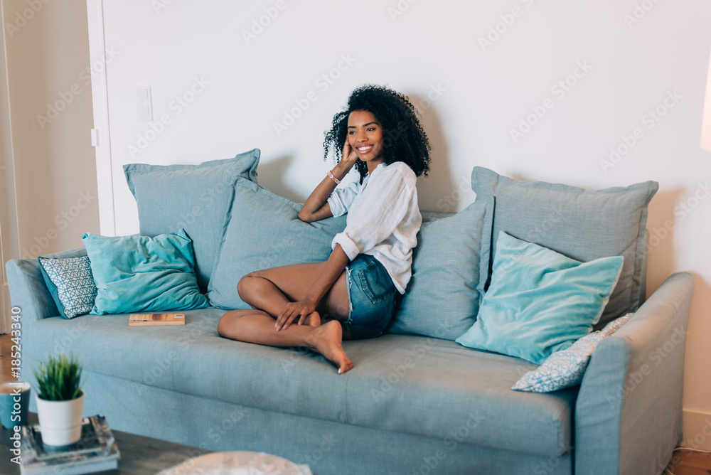 Beautiful black young woman seating in the sofa . Beautiful black young woman seating in the sofa .