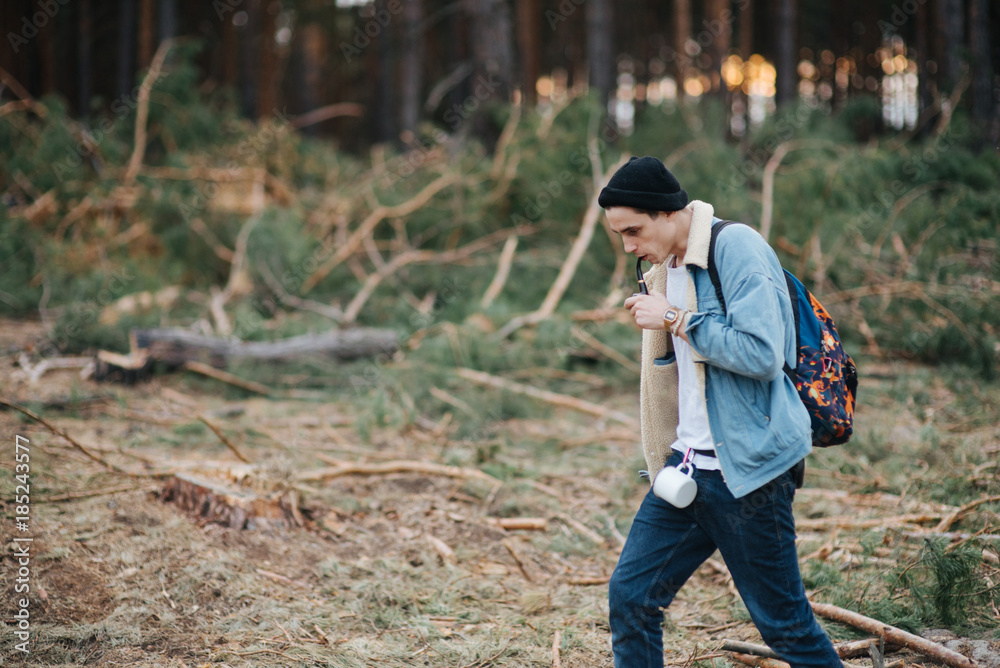 Man with mustache smoke cigarette on forest landscape. Bad habit, addiction concept. Wanderlust, vacation, traveling Man with mustache smoke cigarette on forest landscape. Bad habit, addiction concept. Wanderlust, vacation, traveling