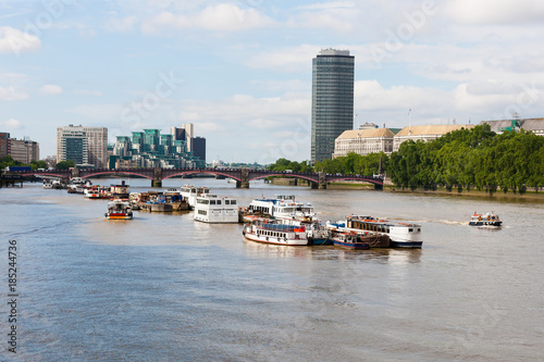 Boats parked along River Thames before Lambeth Bridge, London, England. Leaving little room for other boats to get past.