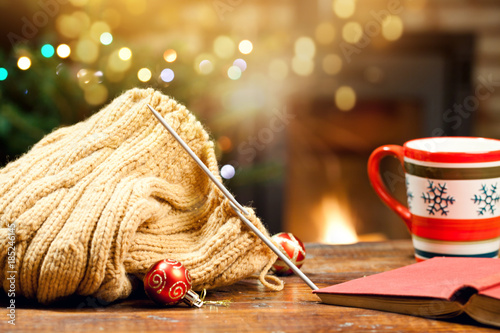Fotografia, Obraz warm woolen knitwear and burning fireplace - cozy winter at home