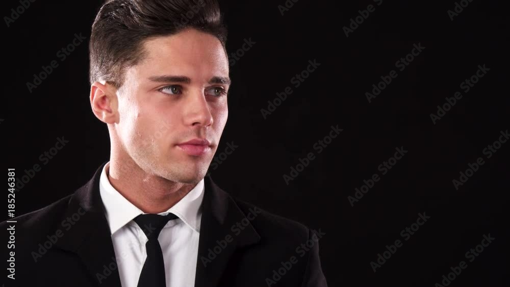 A young man dressed in a suit looks into the distance A young man dressed in a suit looks into the distance