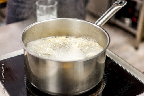pasta in boiling water in pot on electric stove