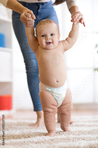 Cute baby boy taking first ...