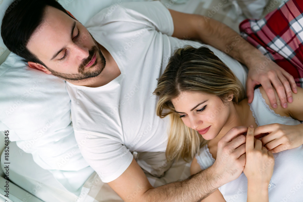 Young attractive couple having romantic time in bed Young attractive couple having romantic time in bed